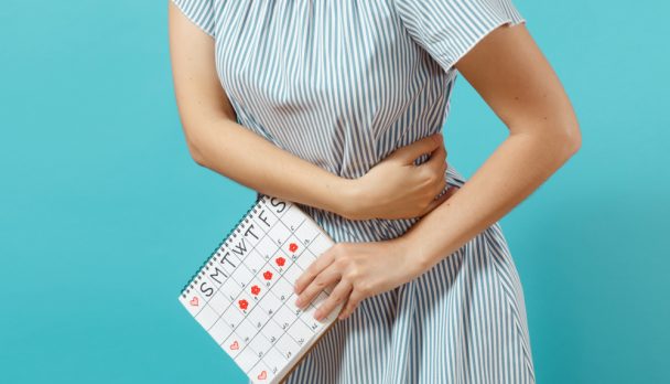 Cropped,Shot,Sickness,Woman,In,Blue,Dress,Holding,Periods,Calendar