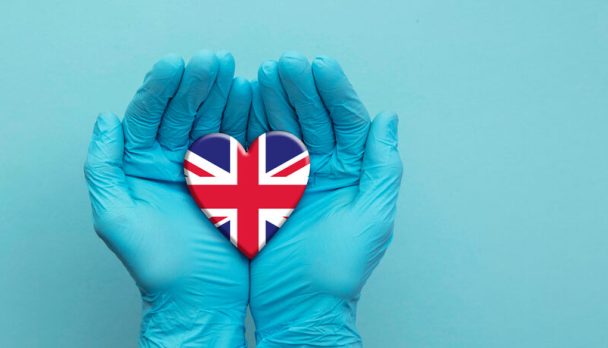 Doctors,Hands,Wearing,Surgical,Gloves,Holding,United,Kingdom,Flag,Heart