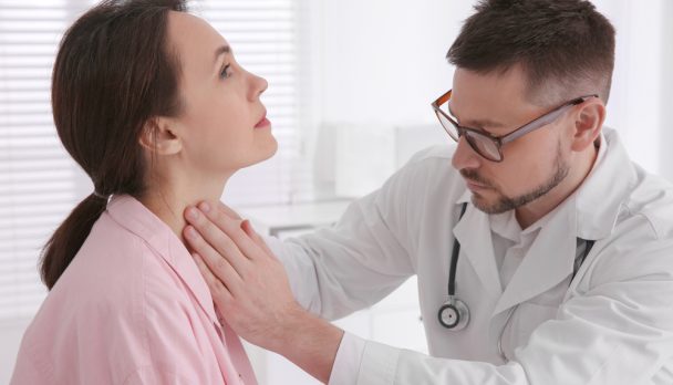 Doctor,Examining,Thyroid,Gland,Of,Patient,In,Hospital