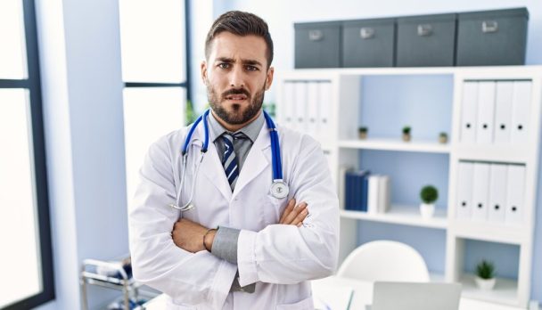 Handsome,Hispanic,Man,Wearing,Doctor,Uniform,And,Stethoscope,At,Medical